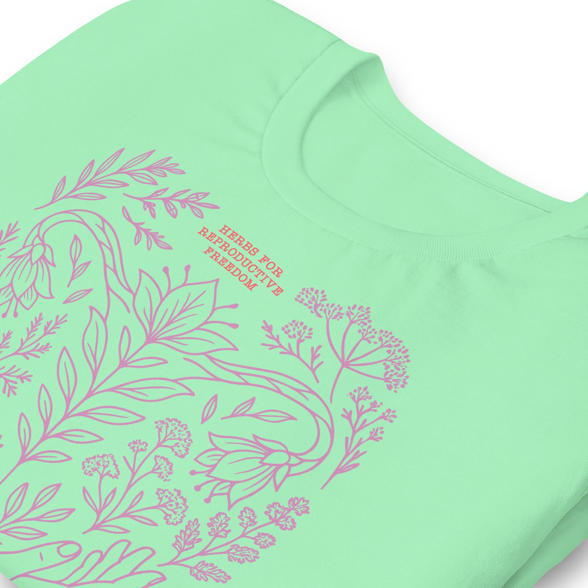 Close-up of the mint green “Herbs for Reproductive Freedom” t-shirt highlighting eco ink details and clean cotton texture. Designed by Blue Wave USA.