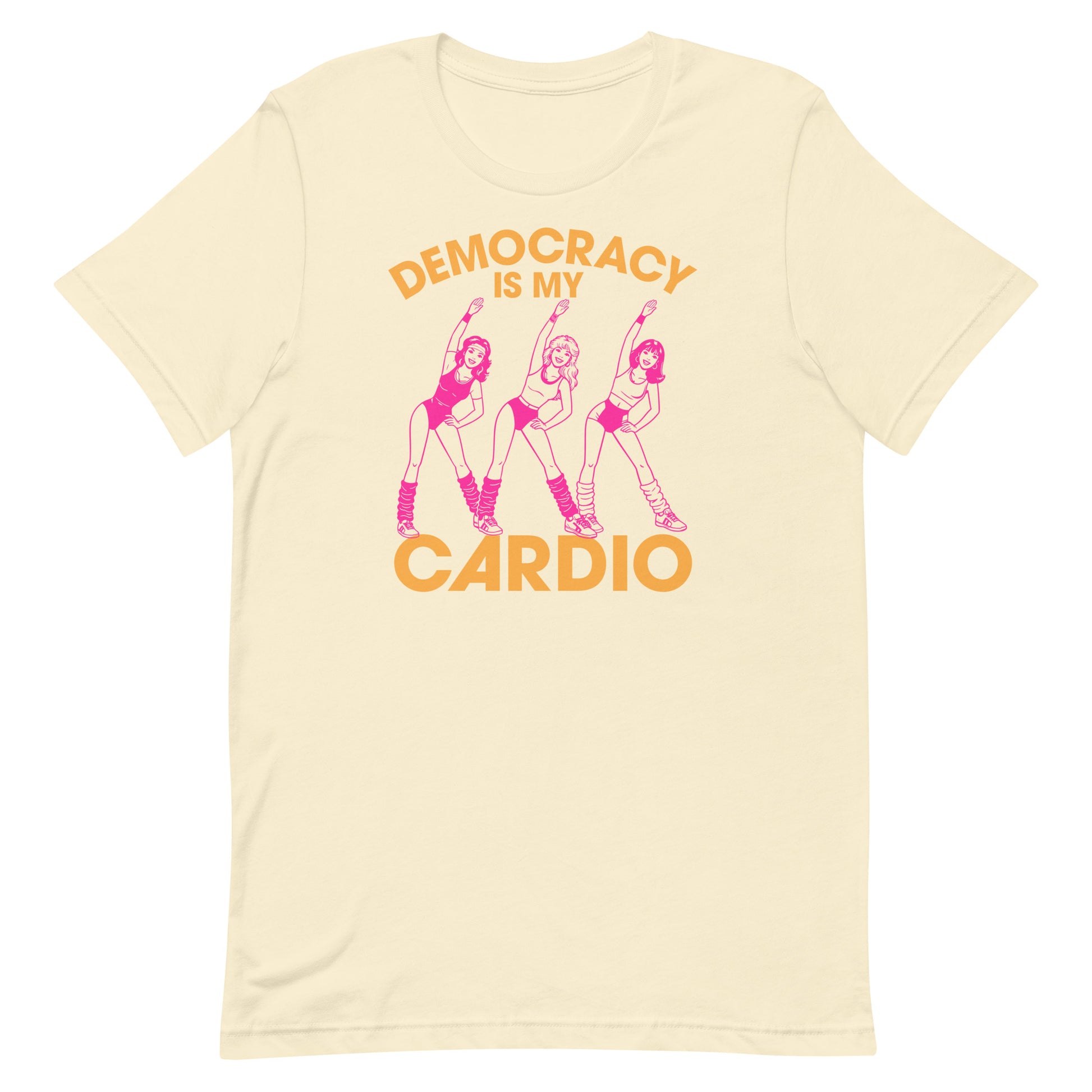 Cream unisex T-shirt showing pink retro fitness dancers with democracy workout message, soft vintage colorway for progressive apparel styling.