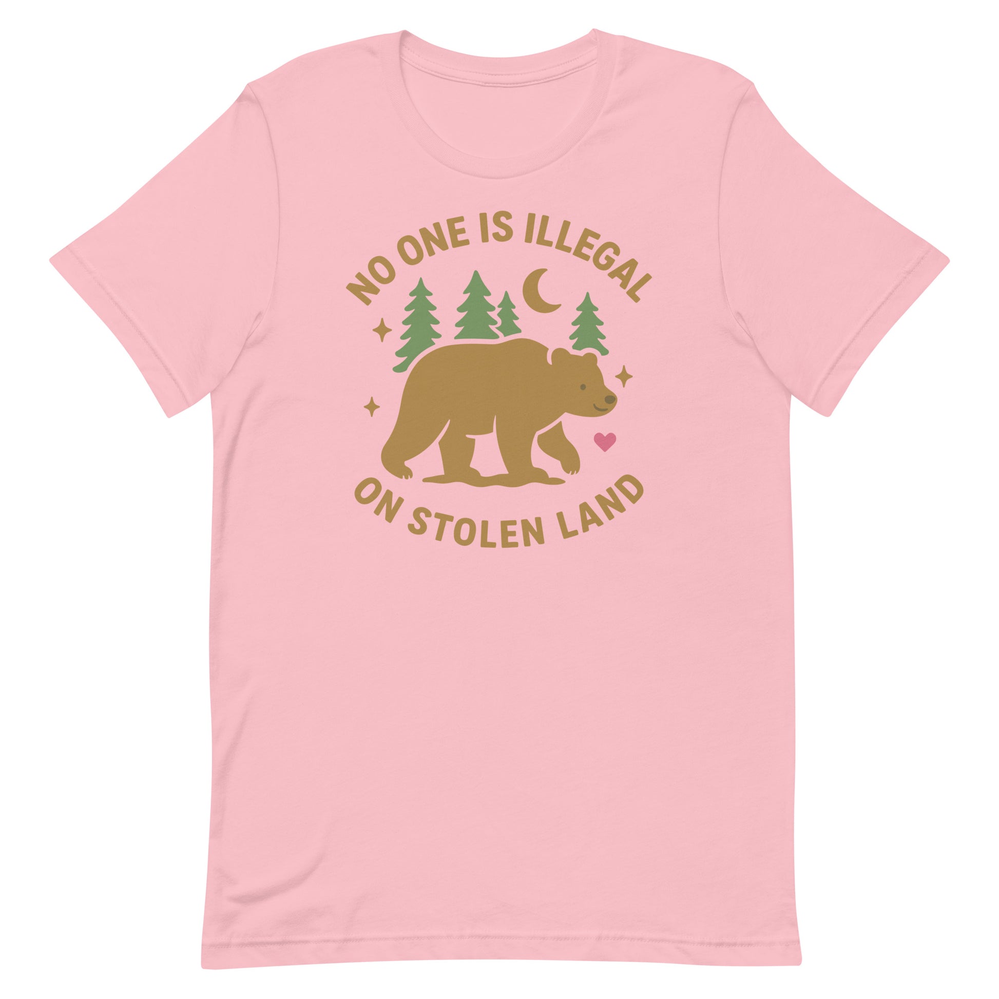 Light pink unisex t-shirt featuring the tan bear, forest, and moon graphic with “NO ONE IS ILLEGAL ON STOLEN LAND,” blending gentle colors with an Indigenous rights message.