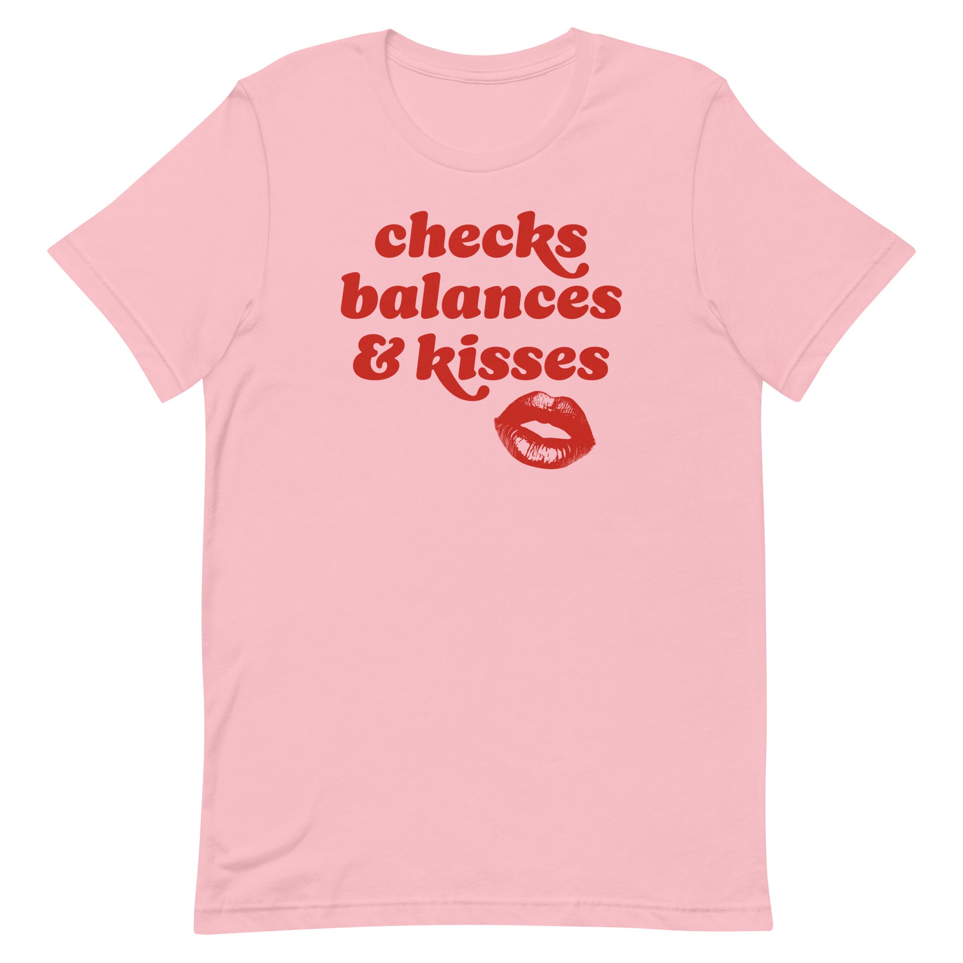 Pink unisex t-shirt featuring retro red typography and lips graphic with the phrase “checks balances & kisses,” a playful Valentine progressive apparel design.
