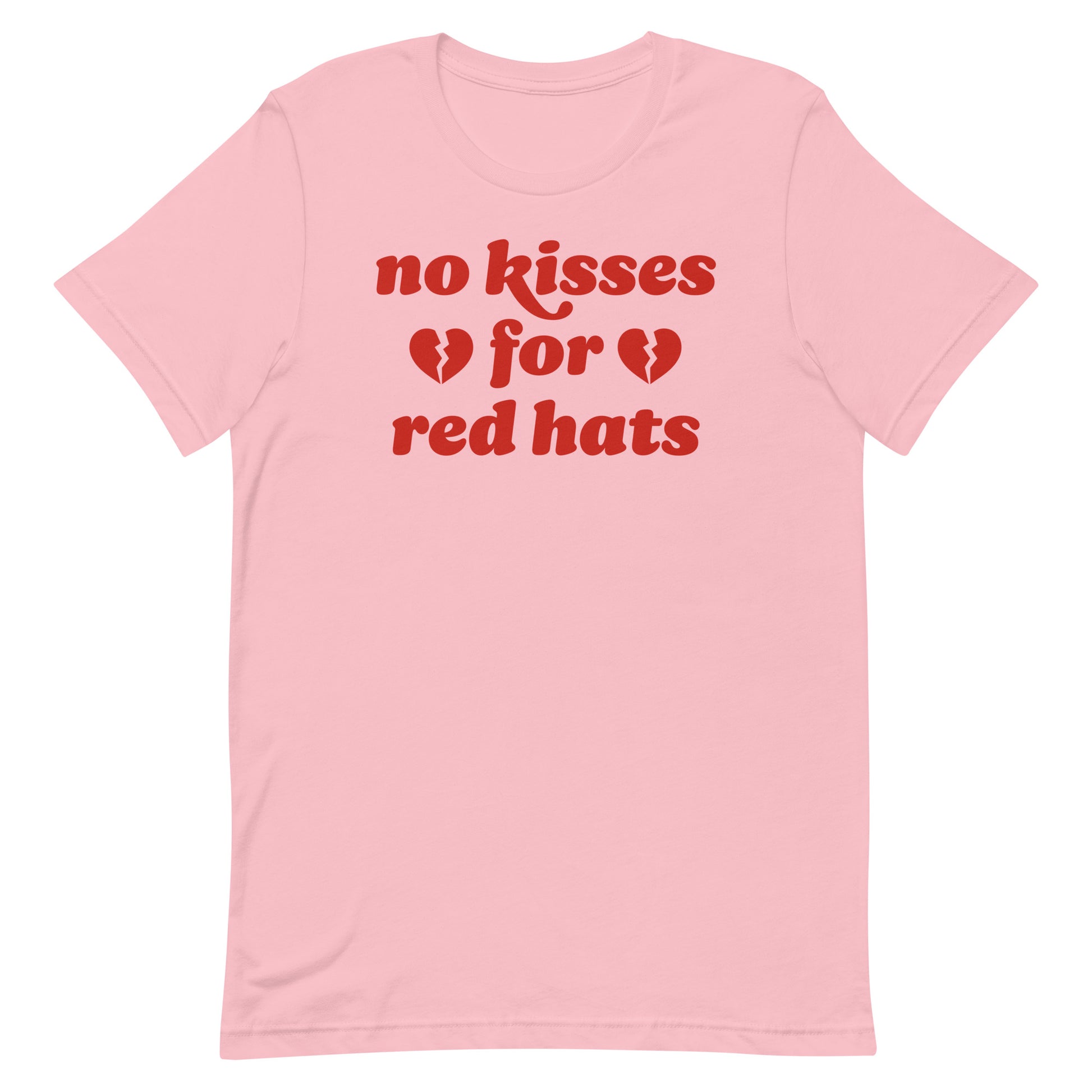 Unisex t-shirt in soft pink featuring the phrase “no kisses for red hats” with broken heart icons, an anti-MAGA Valentine statement in progressive apparel.