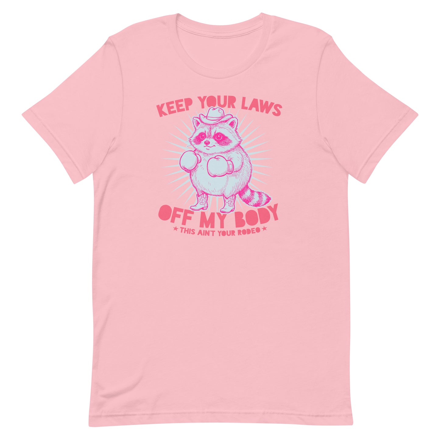 Pink unisex T-shirt displaying raccoon cowboy graphic with reproductive rights slogan in playful western feminist apparel style.