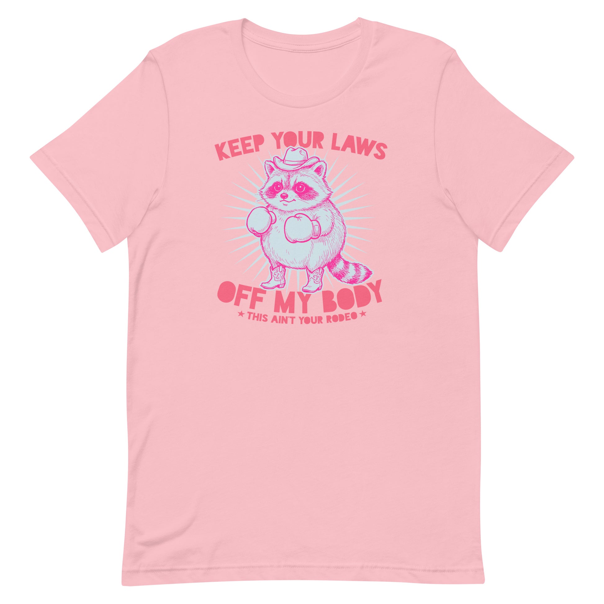 Pink unisex T-shirt displaying raccoon cowboy graphic with reproductive rights slogan in playful western feminist apparel style.