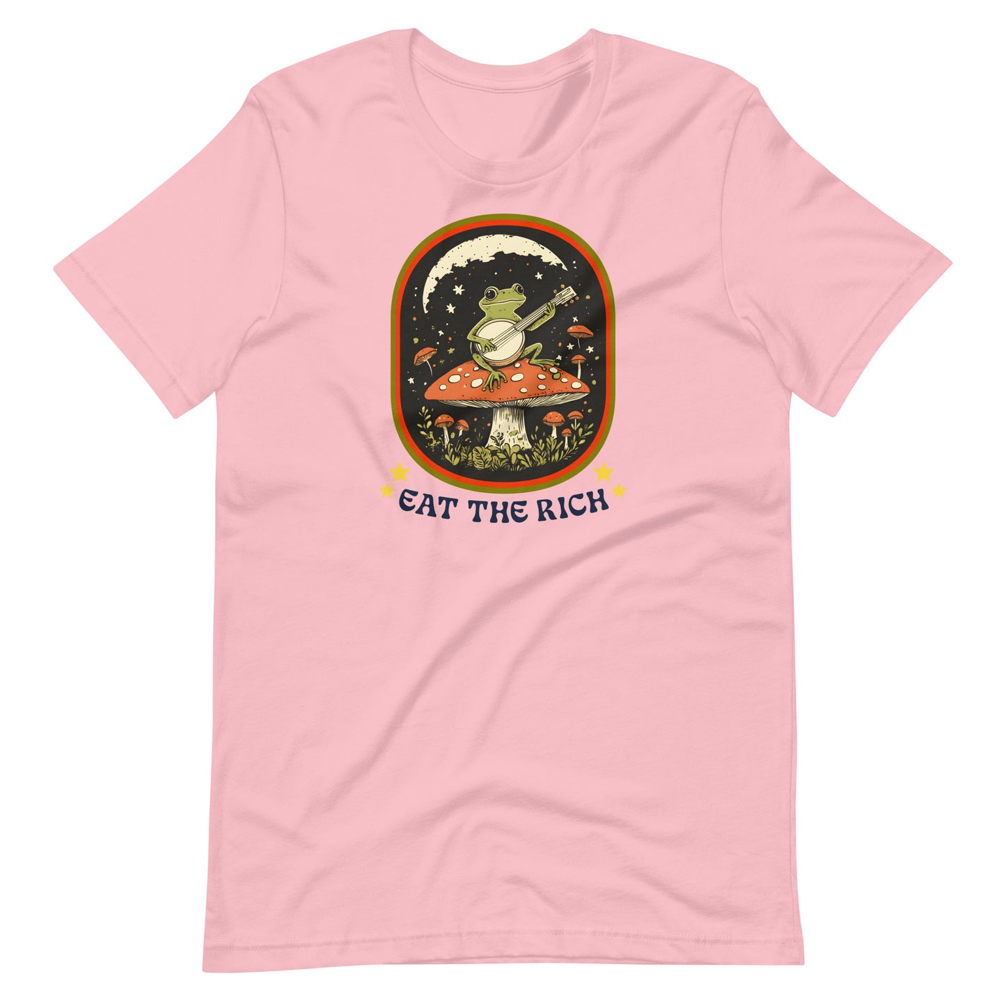 Pink unisex t-shirt showcasing a folk-art frog playing a banjo with vintage-inspired “Eat The Rich” anti-capitalist protest artwork.