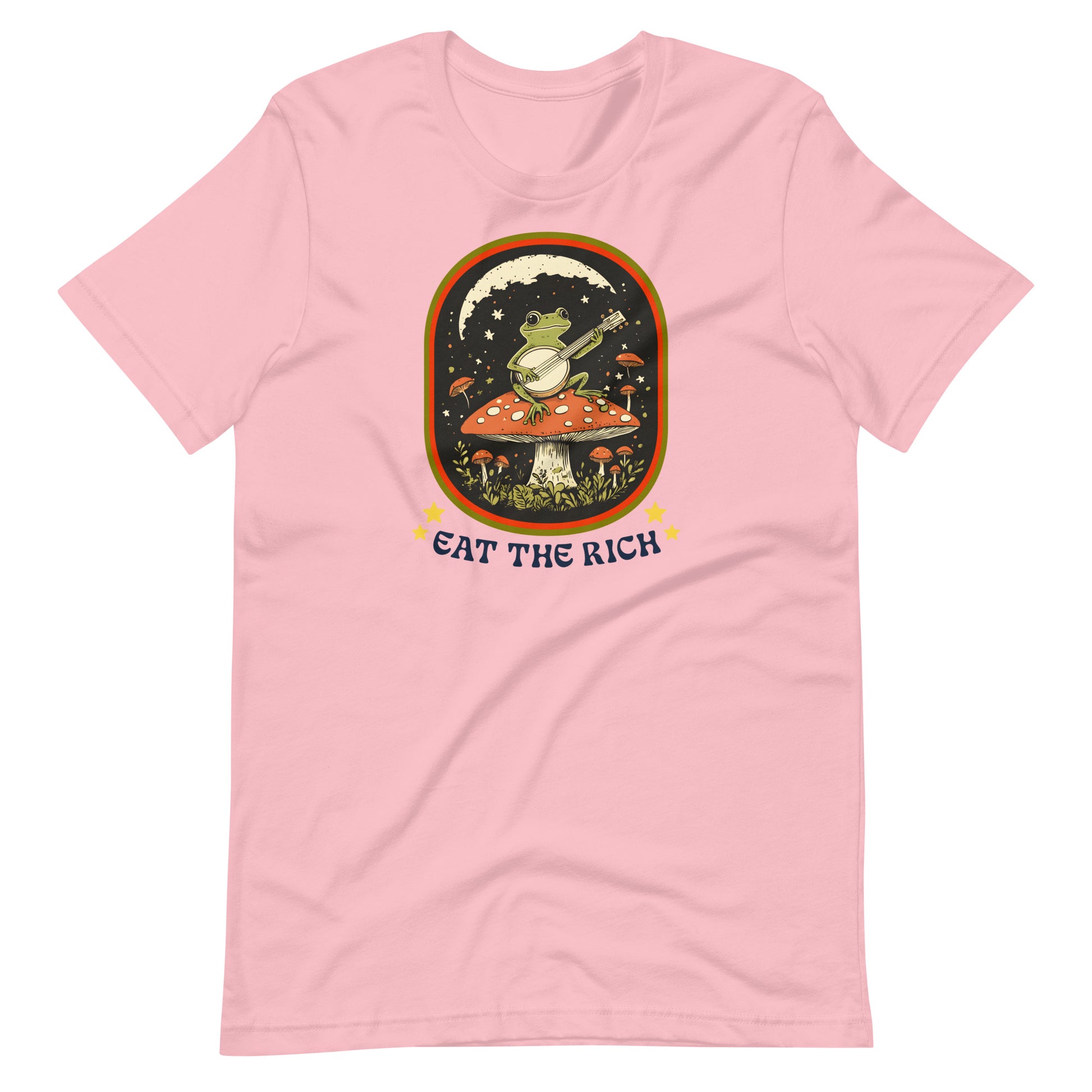 Pink unisex t-shirt showcasing a folk-art frog playing a banjo with vintage-inspired “Eat The Rich” anti-capitalist protest artwork.