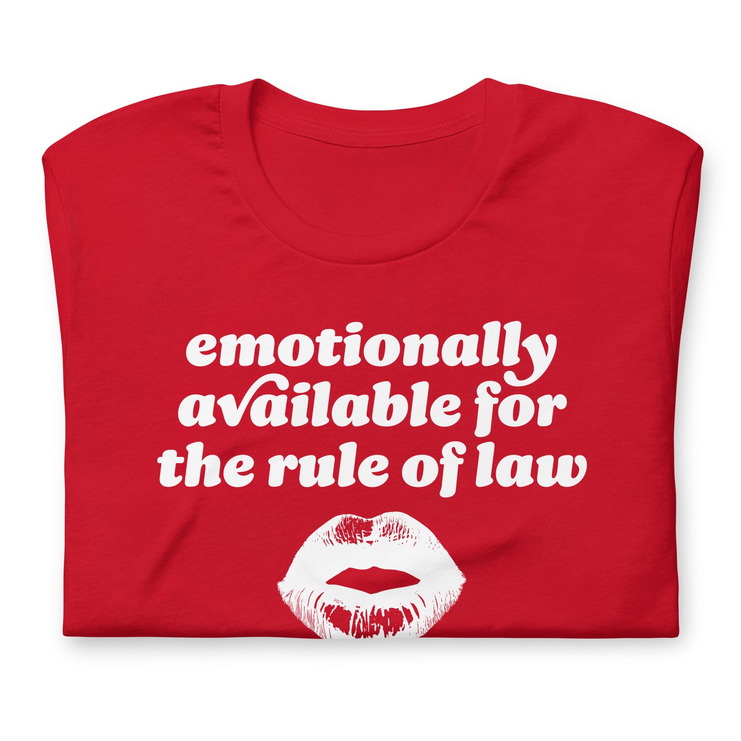 Folded unisex t-shirt detail showing textured print and lips graphic with the phrase “emotionally available for the rule of law,” highlighting Valentine typography.