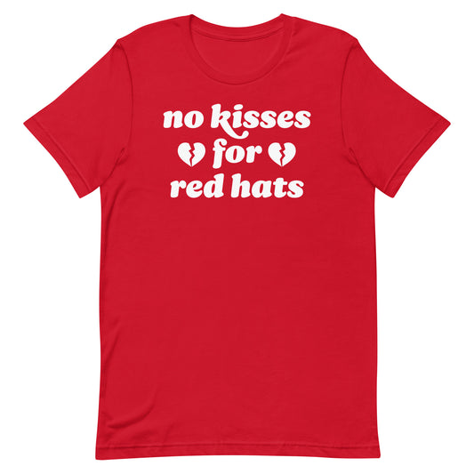 Unisex t-shirt in red with the phrase “no kisses for red hats,” paired with broken hearts, a justice-focused design blending political resistance and Valentine humor.