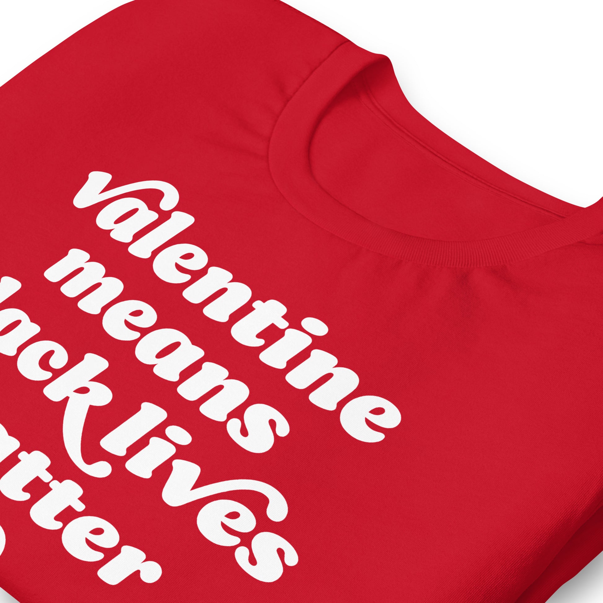 Close-up of red unisex t-shirt highlighting textured retro lettering and heart graphic spelling “Valentine Means Black Lives Matter,” emphasizing print clarity and activist message.