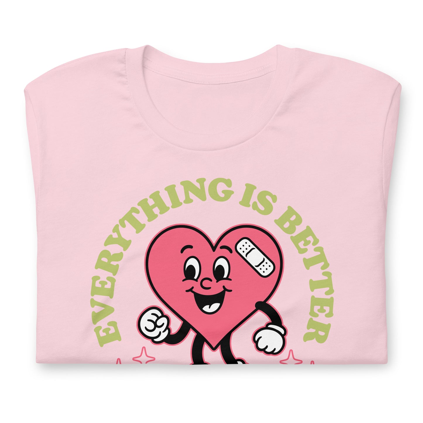 Folded pink “Everything Is Better with Healthcare” t-shirt showing the friendly heart graphic and soft cotton fabric.
