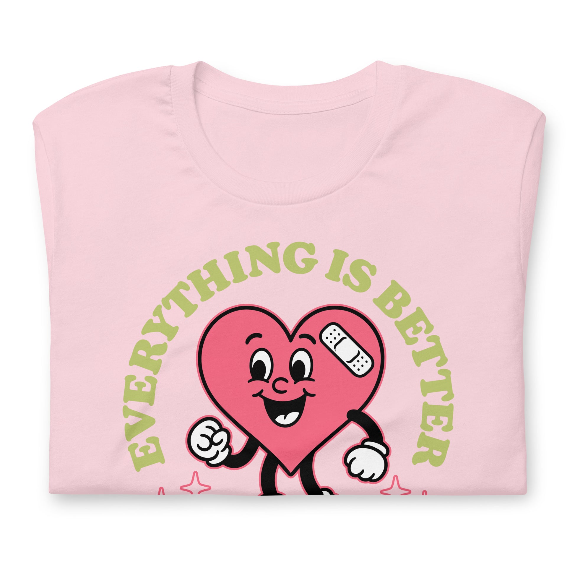 Folded pink “Everything Is Better with Healthcare” t-shirt showing the friendly heart graphic and soft cotton fabric.