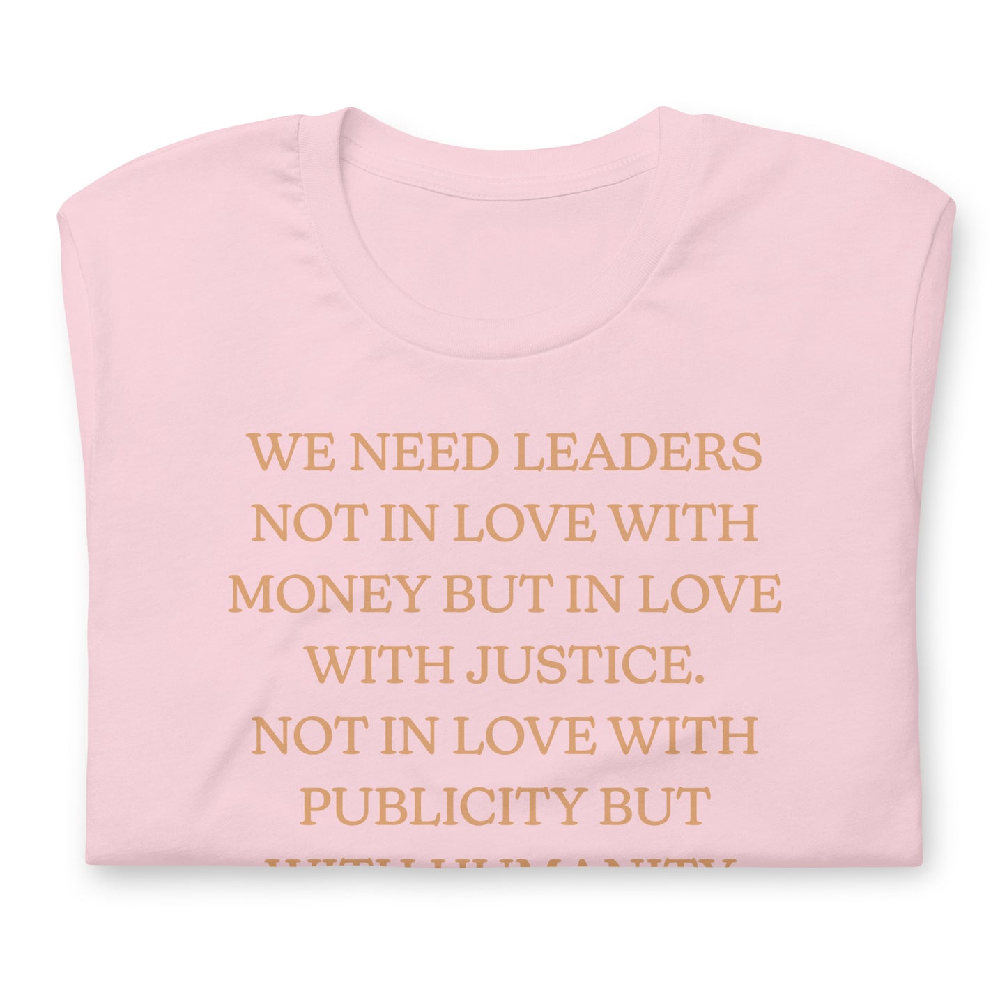 Pink shirt featuring the MLK quote “WE NEED LEADERS NOT IN LOVE WITH MONEY BUT IN LOVE WITH JUSTICE… WITH HUMANITY.” A gentle activist design centered on justice and leadership.