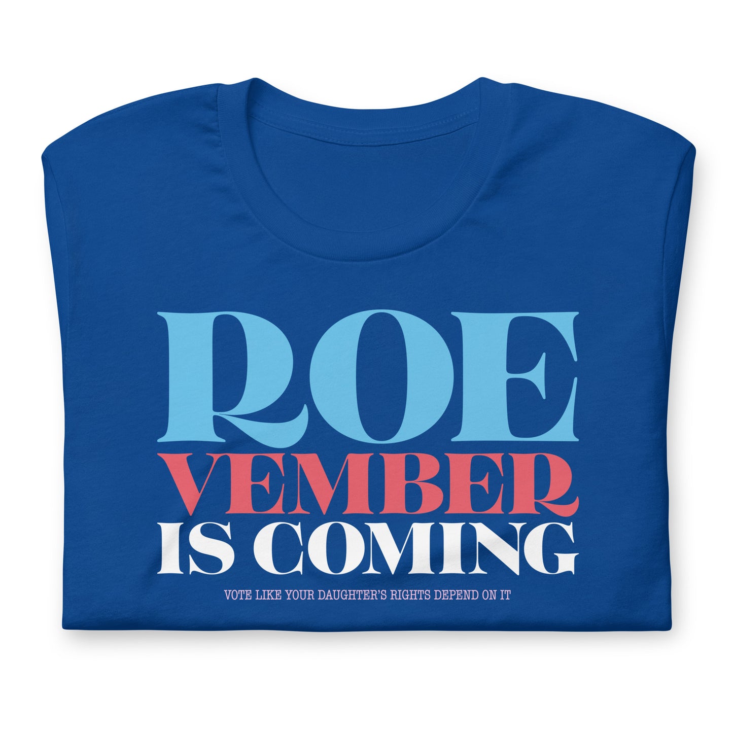 Royal blue unisex t-shirt folded showing bold stacked typography reading “Roevember Is Coming,” progressive voting rights apparel by Blue Wave USA.