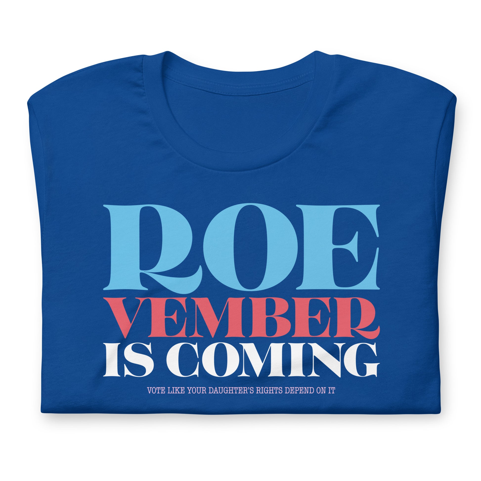 Royal blue unisex t-shirt folded showing bold stacked typography reading “Roevember Is Coming,” progressive voting rights apparel by Blue Wave USA.