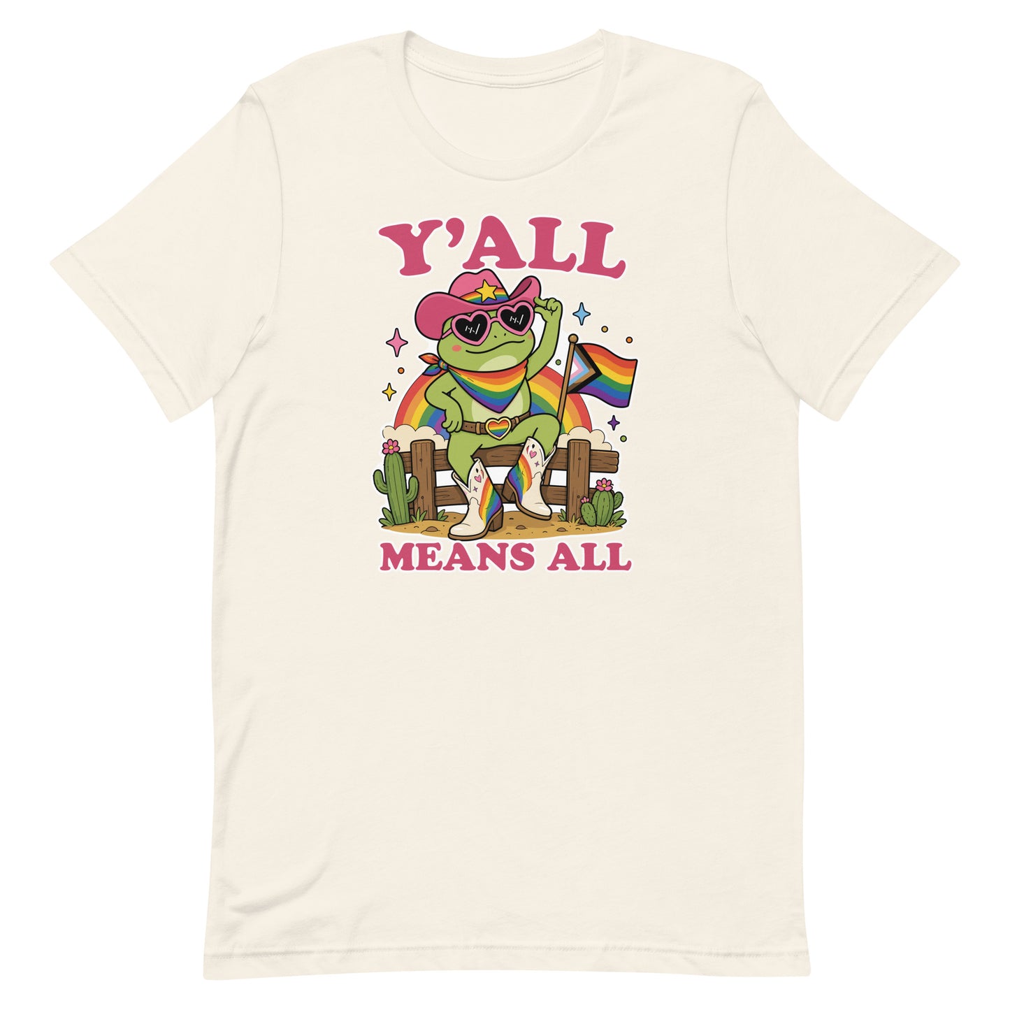 Vintage white unisex t-shirt featuring a cheerful cowboy frog holding a rainbow pride flag with colorful “Y’All Means All” western-inspired pride artwork.