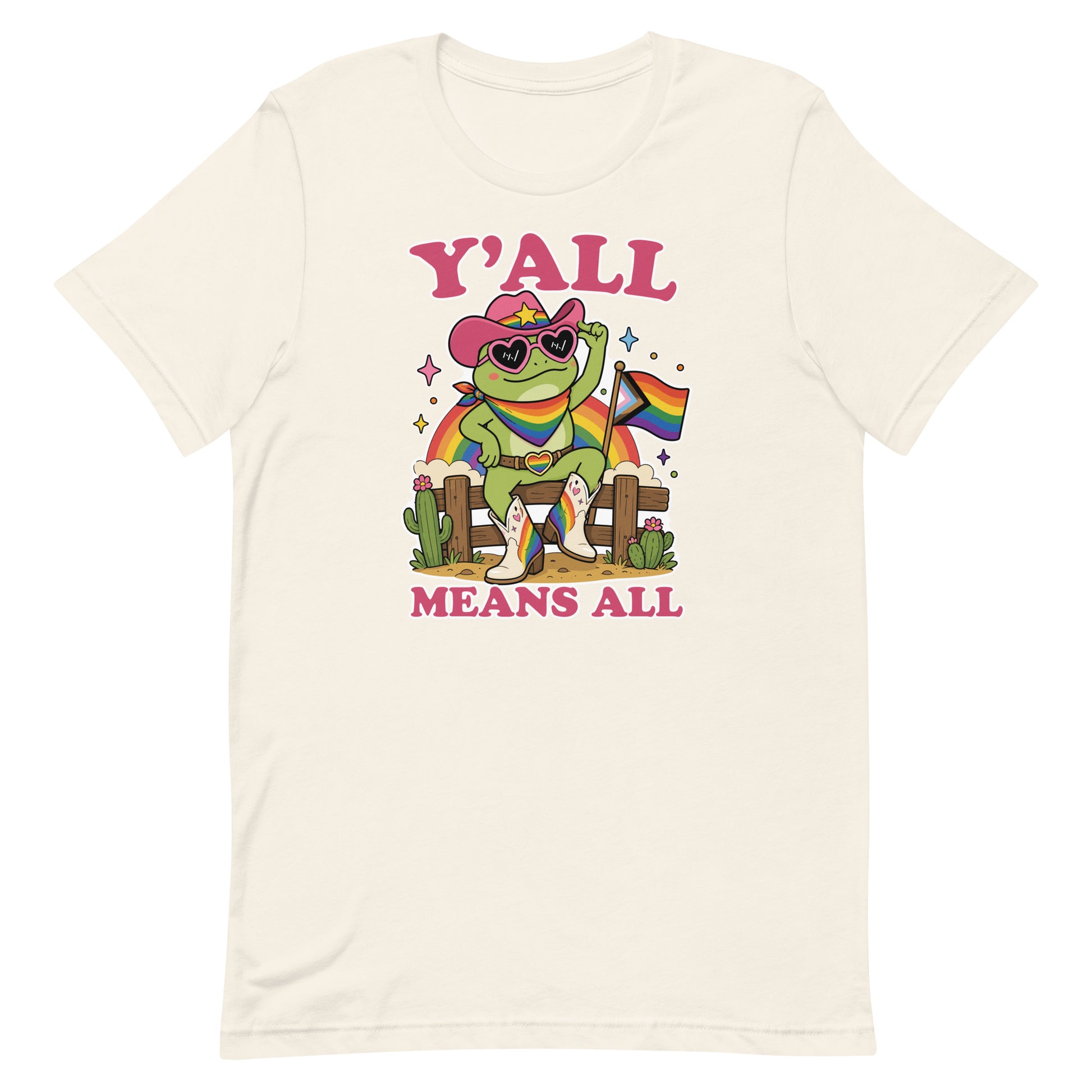 Vintage white unisex t-shirt featuring a cheerful cowboy frog holding a rainbow pride flag with colorful “Y’All Means All” western-inspired pride artwork.