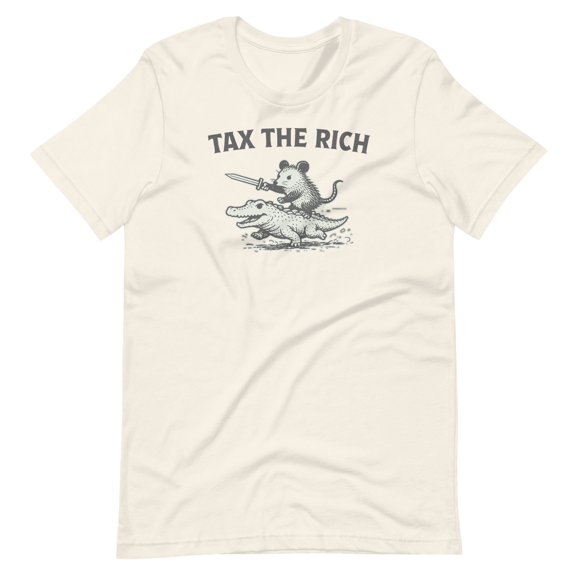 Natural-colored t-shirt showcasing a distressed black-and-white opossum riding an alligator graphic with the phrase “Tax the Rich” in bold typography.