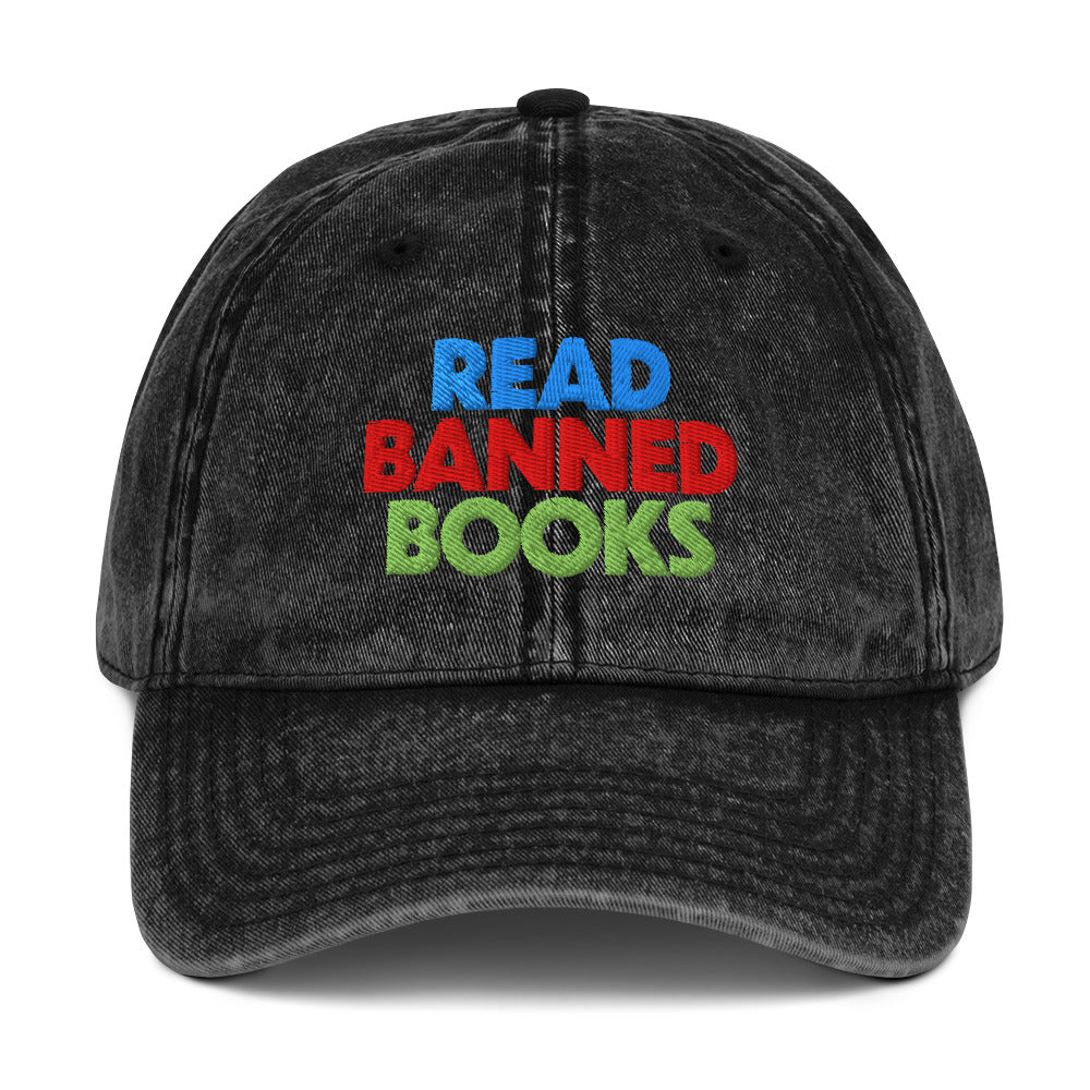 Black washed vintage cap embroidered with “Read Banned Books” in bold blue, red, and green lettering, celebrating intellectual freedom and the freedom to read.