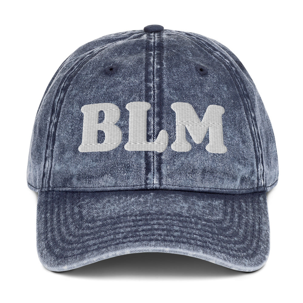 Blue vintage cotton twill cap with raised embroidered “BLM” lettering, washed denim-like texture, curved brim, and unstructured dad hat design by Blue Wave USA.