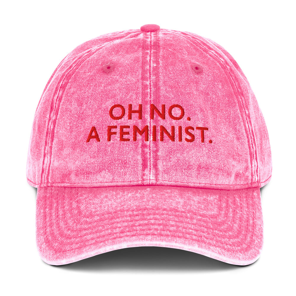 Pink embroidered vintage cap featuring the phrase “OH NO. A FEMINIST.” in contrasting lettering, designed for everyday feminist expression.