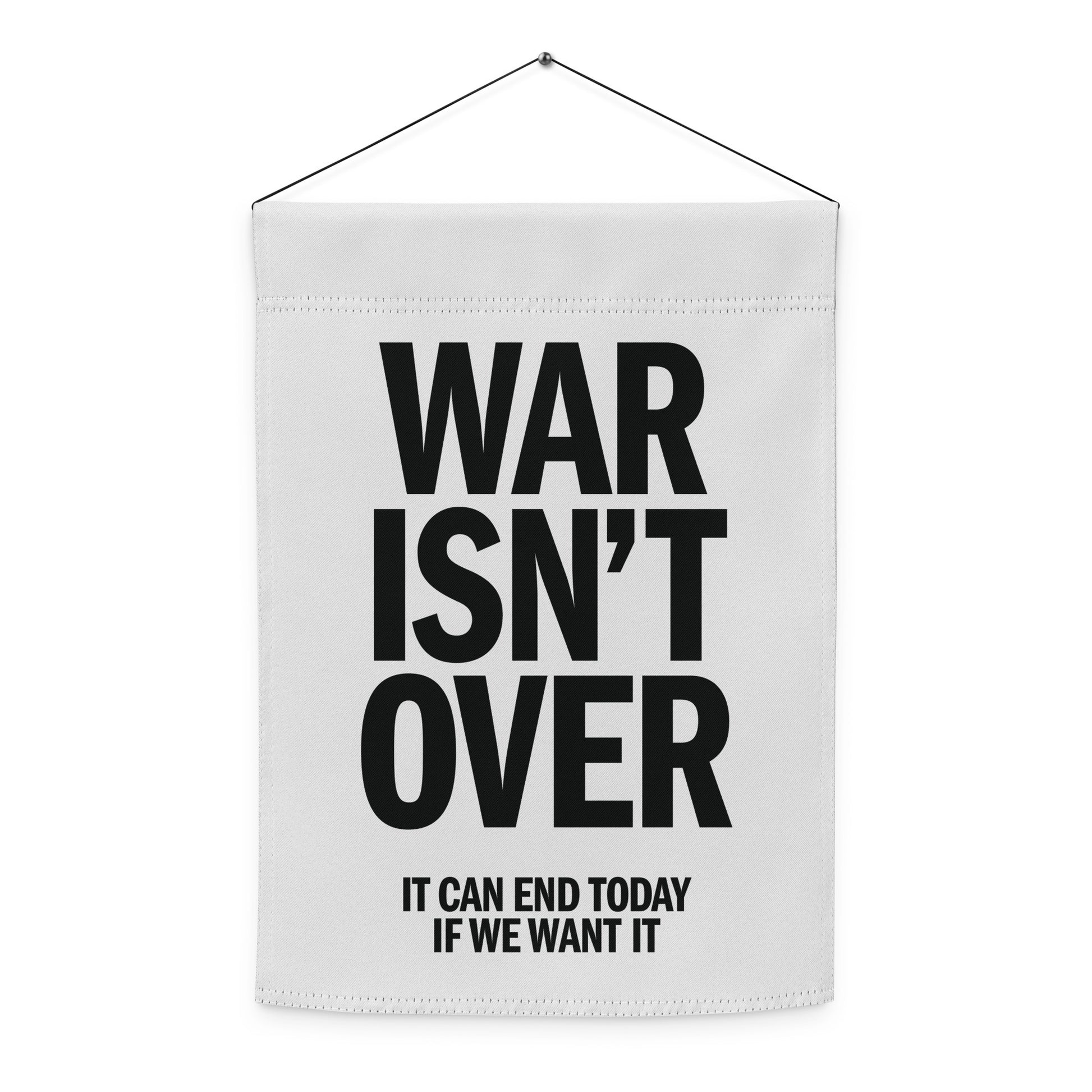 Hanging garden flag featuring bold black anti-war typography reading “WAR ISN’T OVER,” minimalist peace design for justice-focused yard decor.