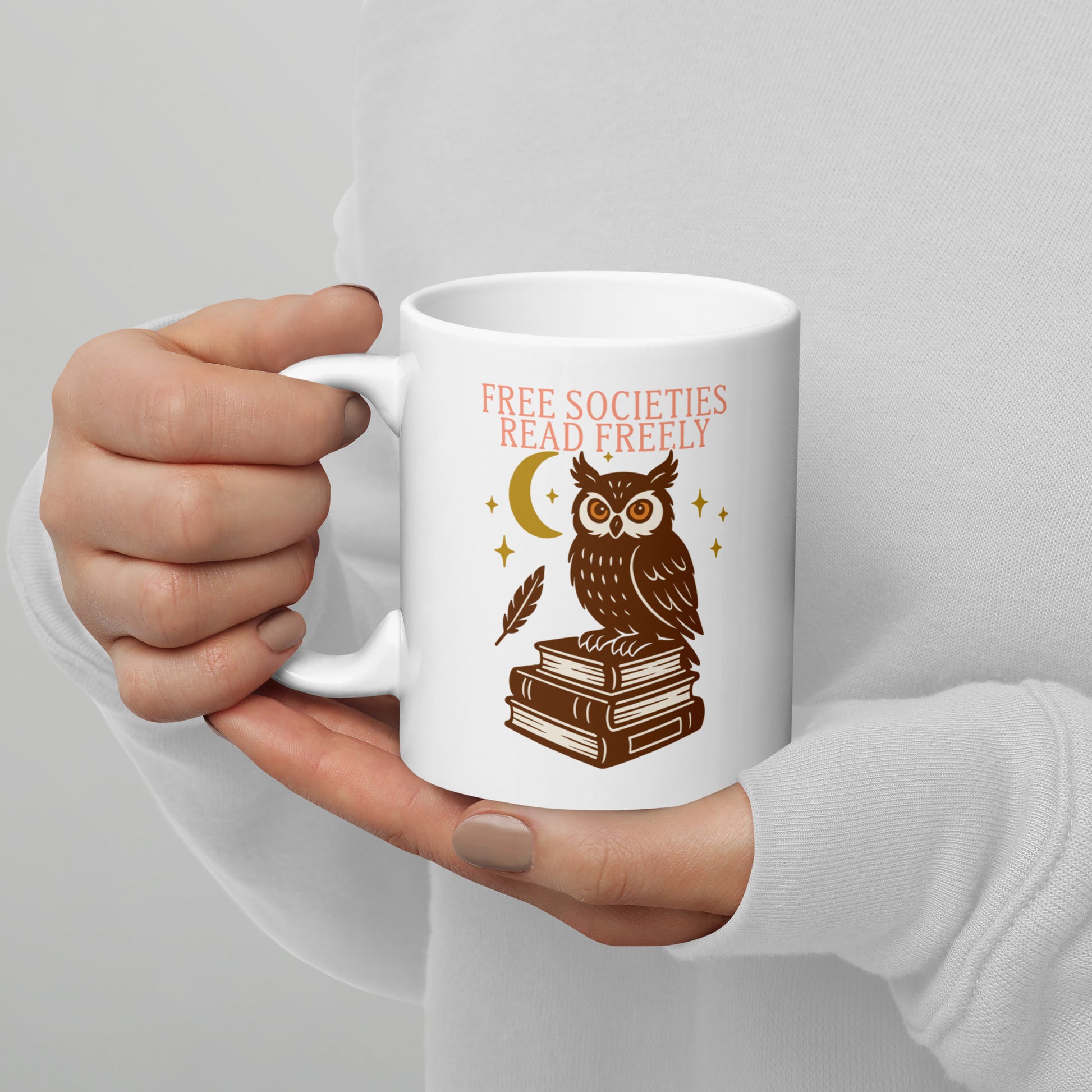 White ceramic mug with “Free Societies Read Freely” owl and books design, literary activism graphic for book lovers.