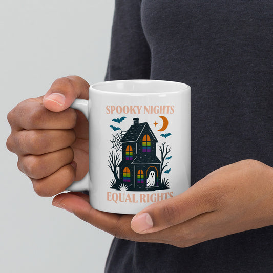 White ceramic mug featuring “Spooky Nights, Equal Rights” haunted house and ghost design, Halloween activist coffee mug for equality lovers.