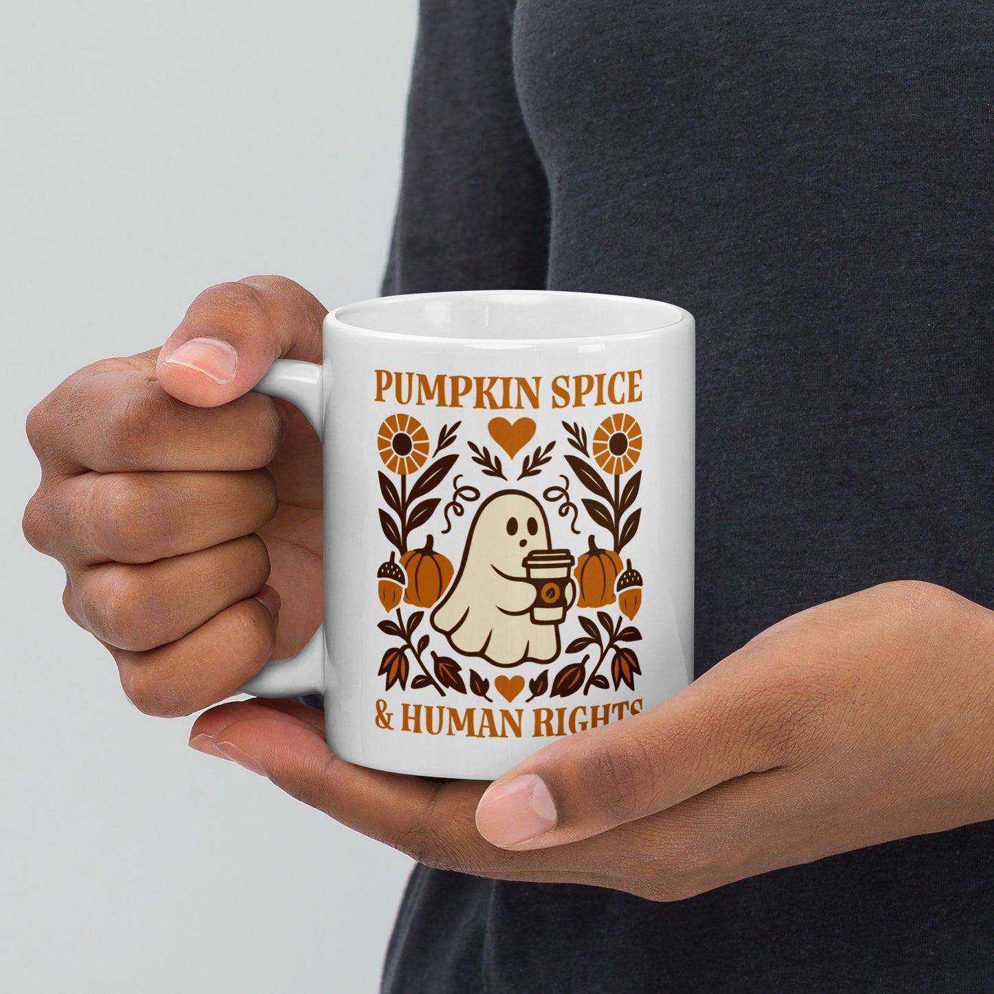White ceramic mug with “Pumpkin Spice & Human Rights” cozy ghost and pumpkin design, autumn equality drinkware for activists.