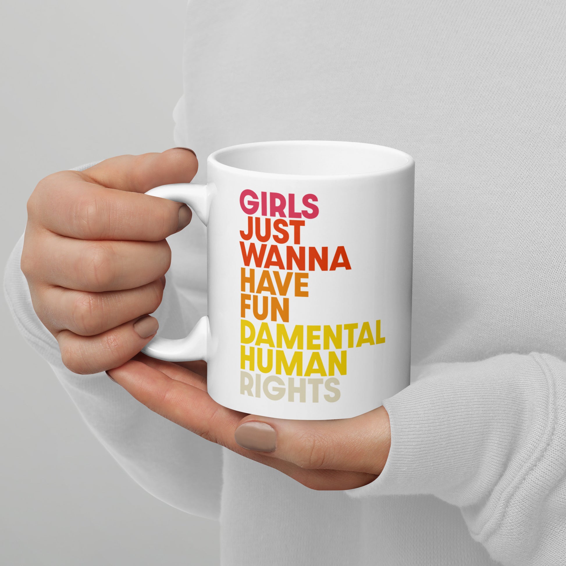 White glossy mug with colorful stacked text reading “Girls Just Wanna Have Fundamental Human Rights,” feminist equality coffee mug by Blue Wave USA.