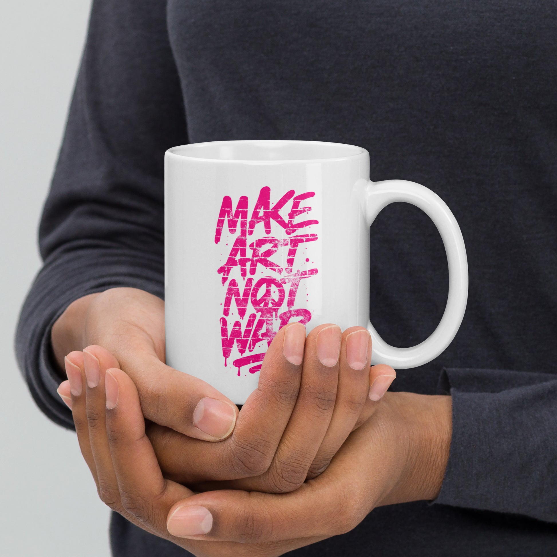 Front View Image: Front view of the 11 oz glossy mug with Make Art Not War graffiti design in pink spray-paint lettering