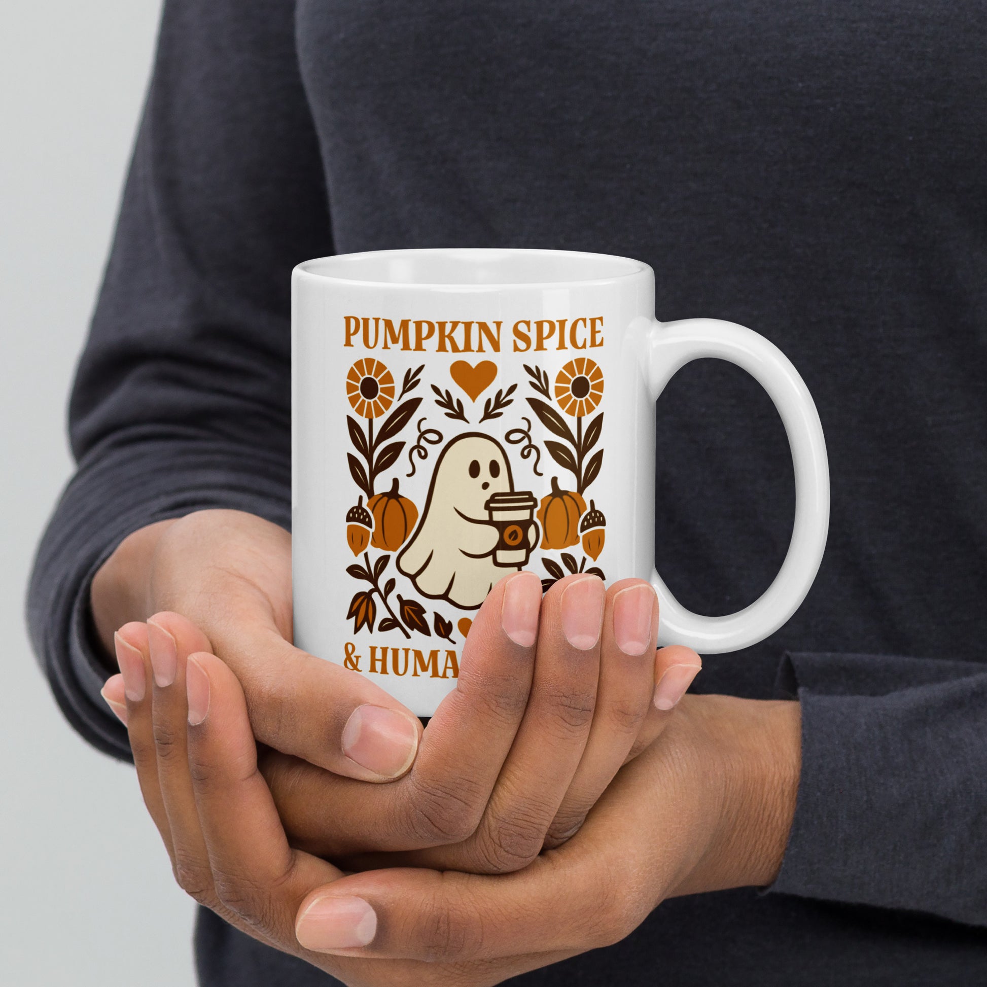 Person holding 11 oz “Pumpkin Spice & Human Rights” mug with fall ghost graphic, Blue Wave USA progressive home & lifestyle gift.