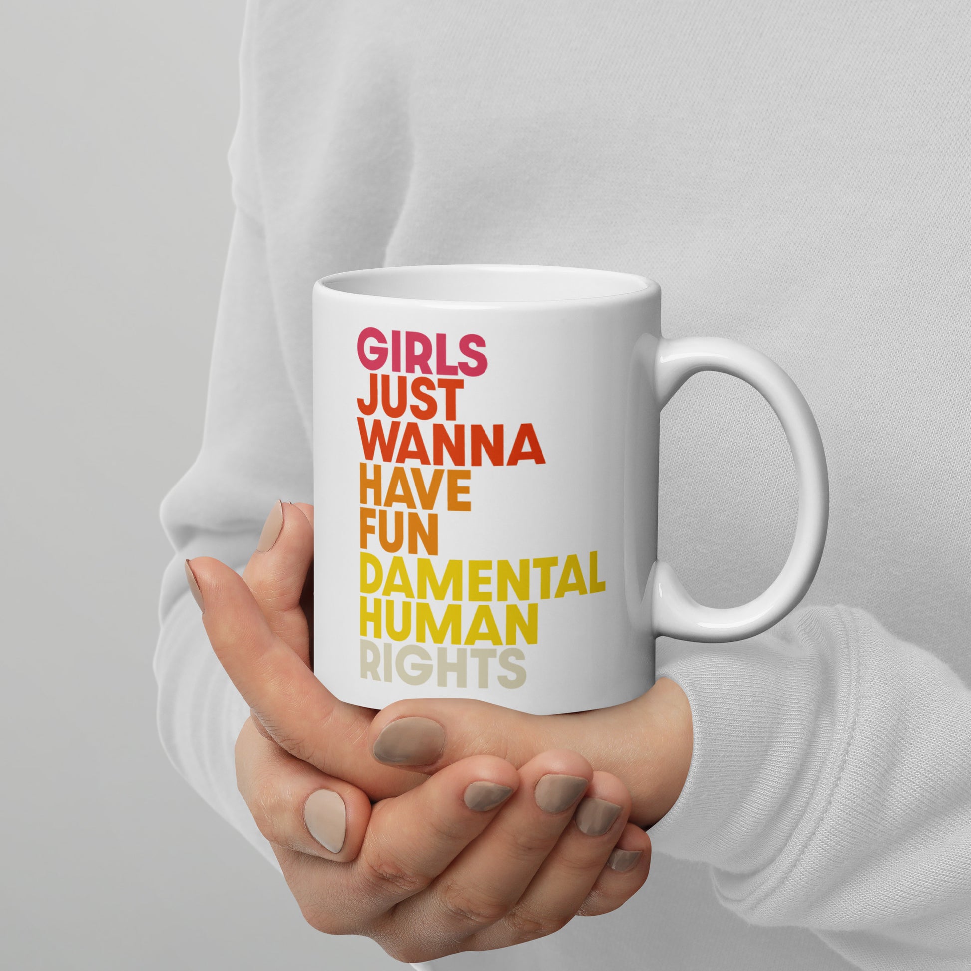 Person holding 11 oz white “Girls Just Wanna Have Fundamental Human Rights” feminist mug, cozy Blue Wave USA activism-inspired drinkware.