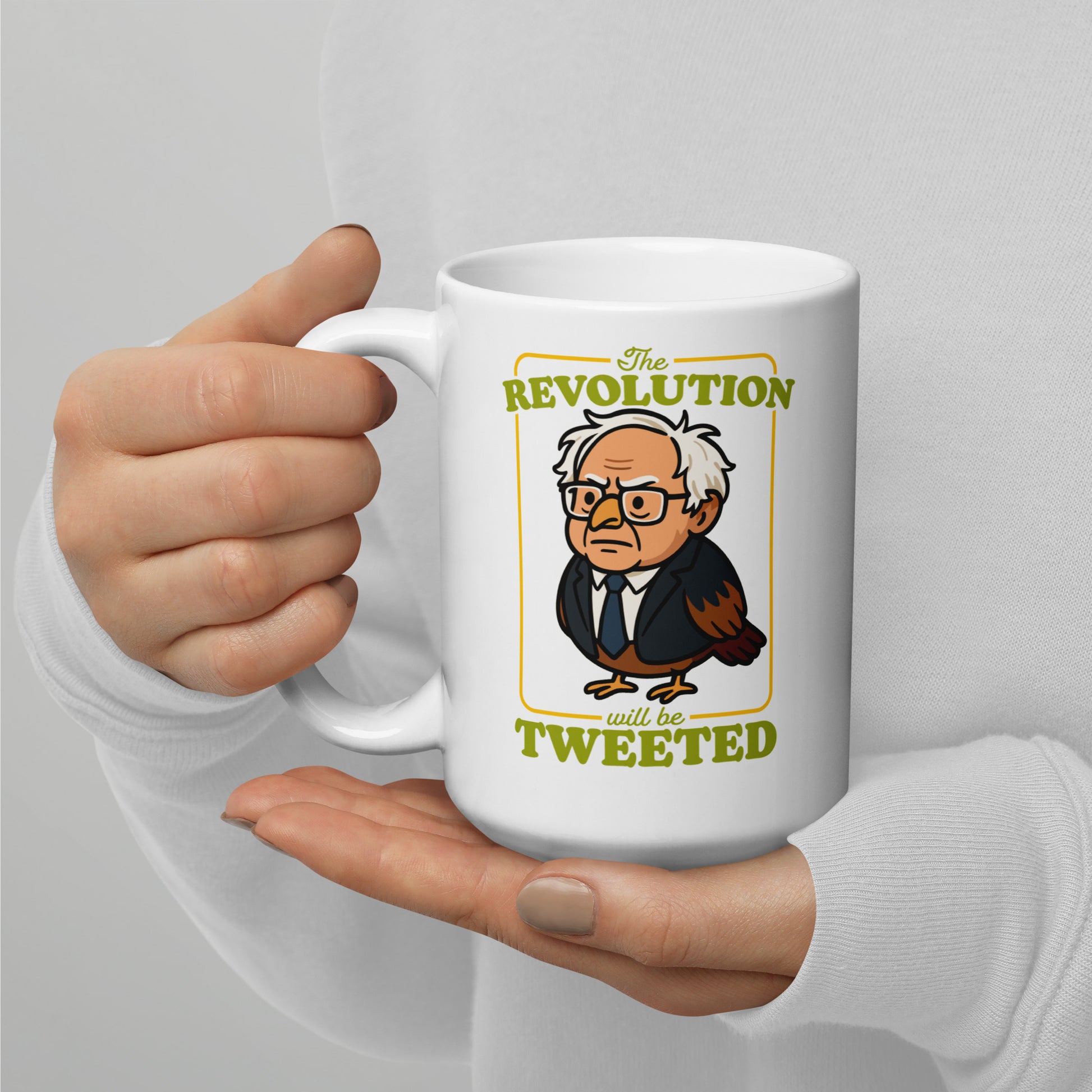 White coffee mug featuring Birdie Sanders portrait and “The Revolution Will Be Tweeted” phrase, political humor gift for desks and reading nooks.