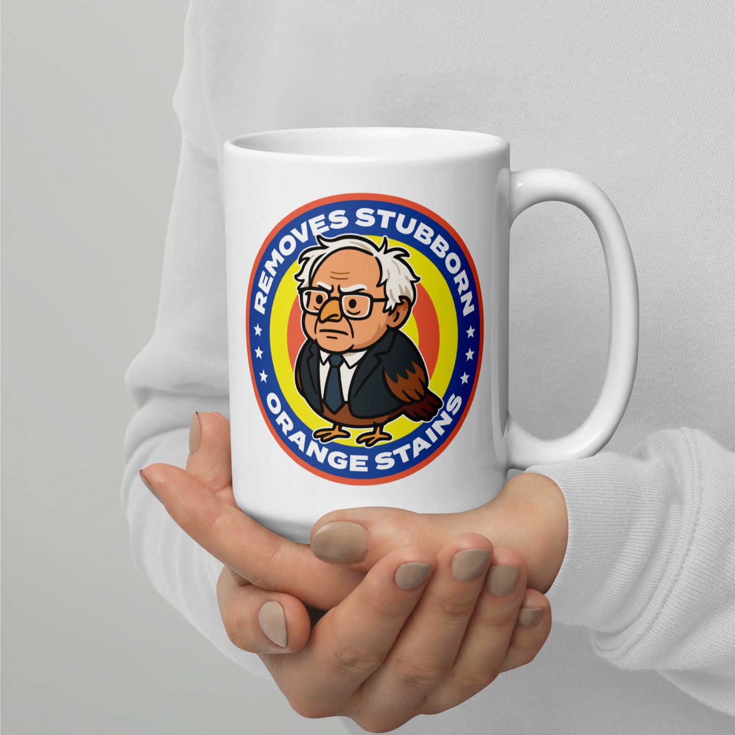Ceramic mug mockup showing Birdie Sanders parody cleaning label with orange stains phrase in playful activist gift design.