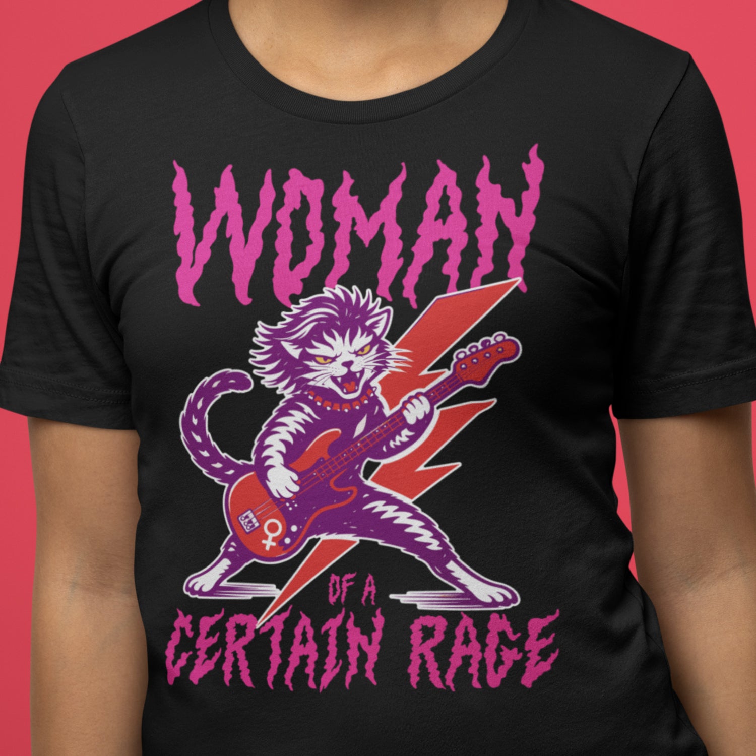 Close-up of a black women’s relaxed t-shirt showing the punk rock cat guitar illustration and distressed text reading “WOMAN OF A CERTAIN RAGE,” graphic detail from Blue Wave USA.