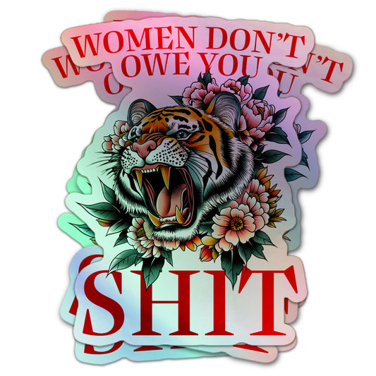 Holographic sticker with a roaring tiger surrounded by flowers and the bold text: “Women Don’t Owe You Shit.”