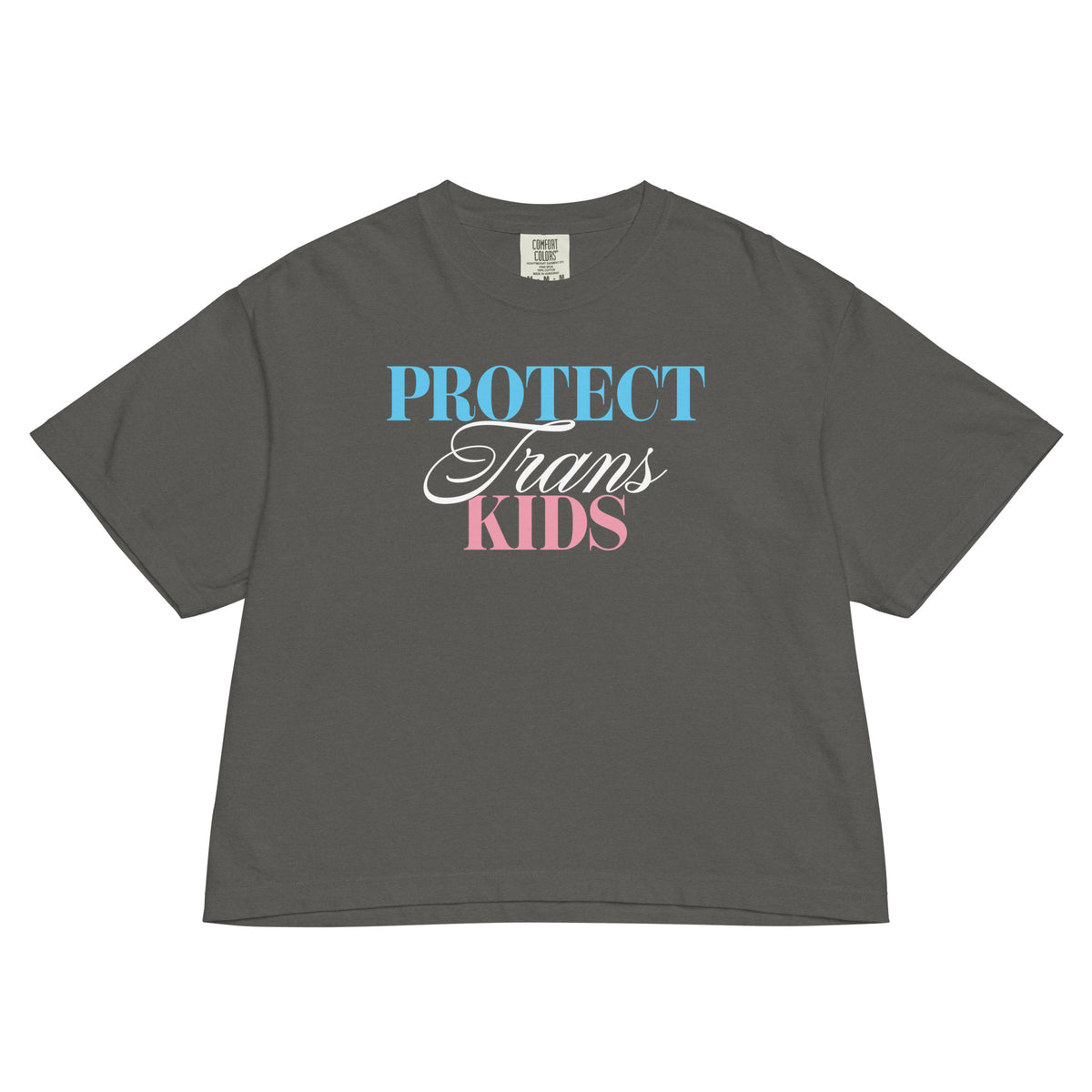 Pepper women’s boxy tee featuring the “Protect Trans Kids” graphic in trans pride-inspired blue, white, and pink lettering.