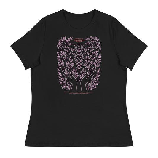 Black women’s relaxed t-shirt featuring a pink botanical illustration of hands, herbs, and crescent moon with the phrase “Herbs for Reproductive Freedom.”