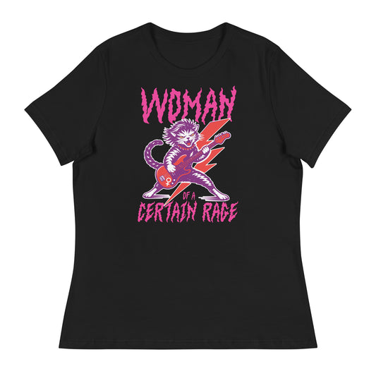 Black women’s relaxed t-shirt featuring a feminist punk rock cat playing electric guitar with bold distressed lettering reading “WOMAN OF A CERTAIN RAGE,” vibrant pink and purple graphic centered.