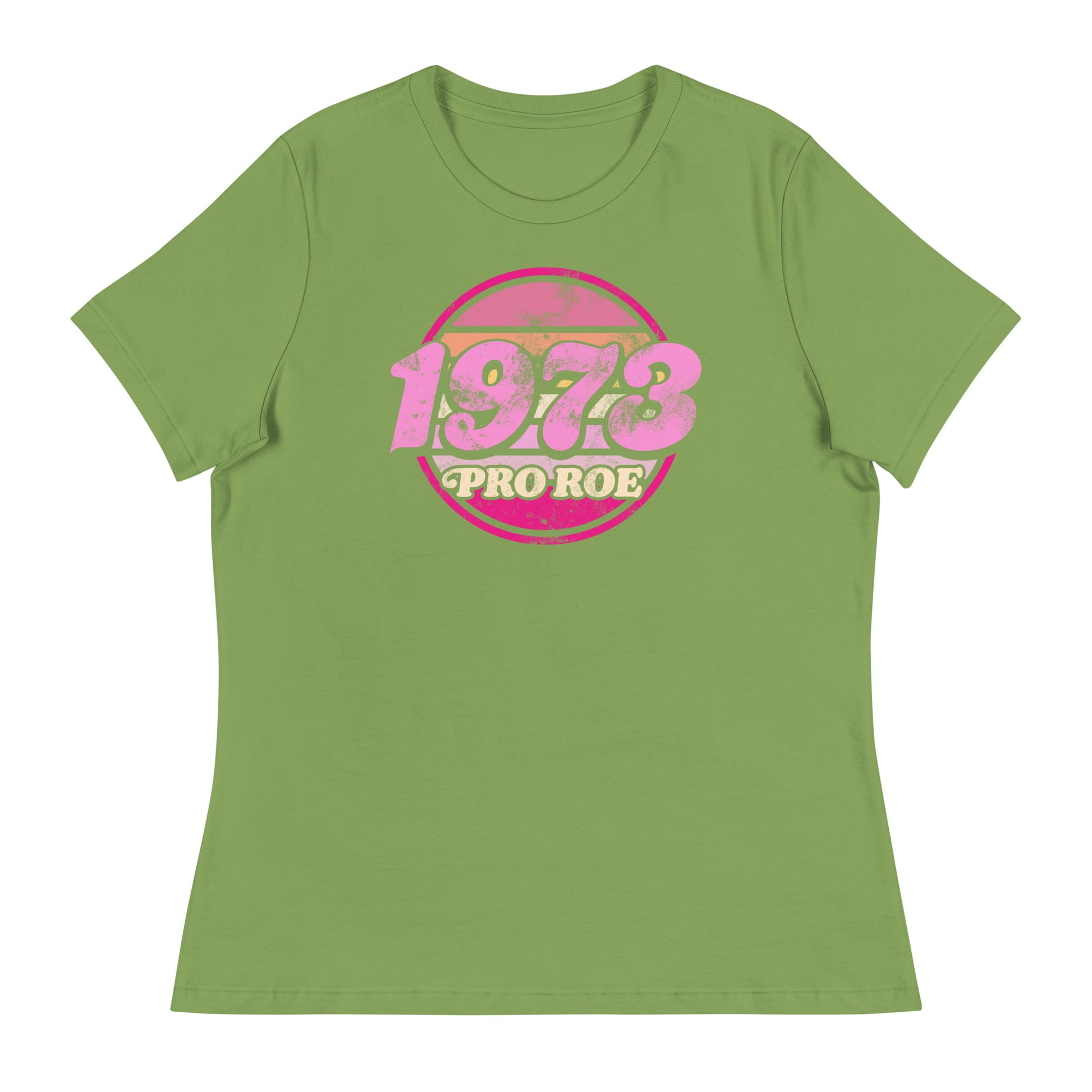 Leaf green women’s relaxed t-shirt featuring a distressed retro circular badge reading “1973 PRO ROE,” vintage reproductive freedom graphic centered on a soft pastel garment.
