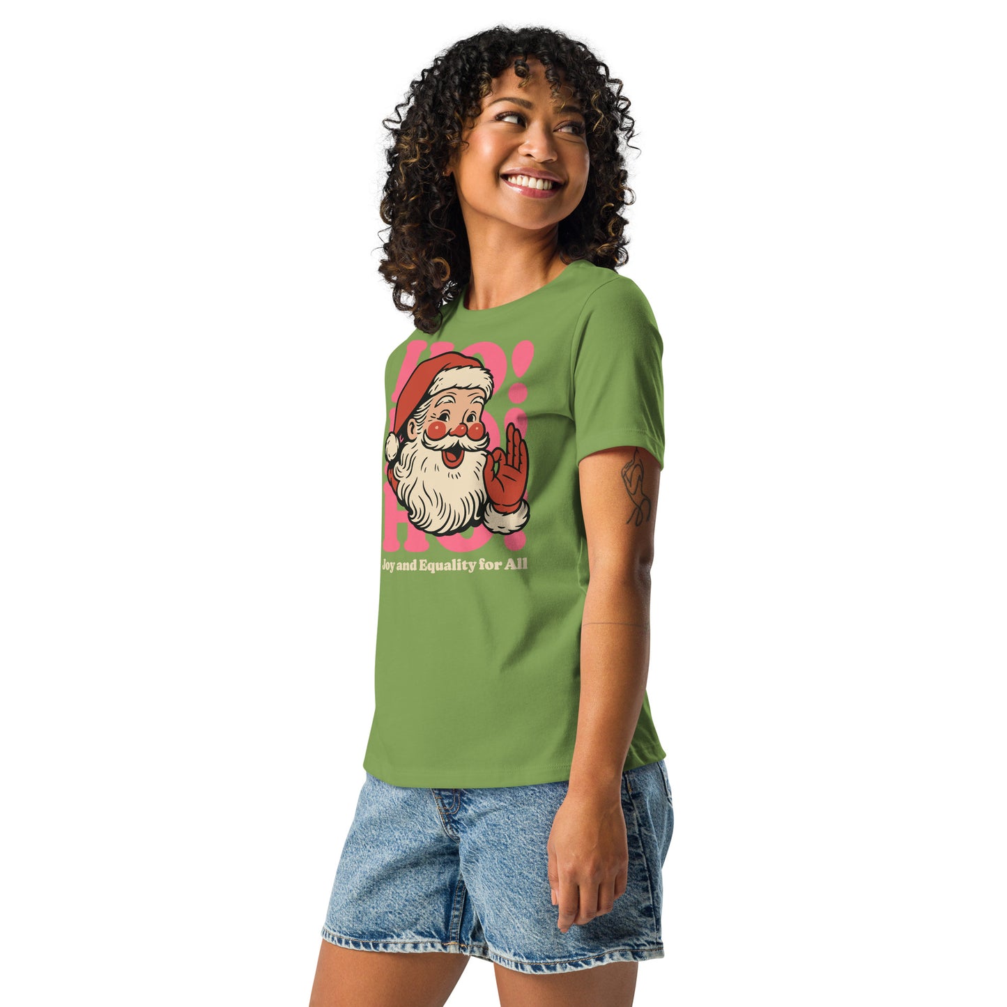 Full-body shot of a person wearing the leaf green women’s fit shirt with the vintage Santa graphic and “Joy and Equality for All.”