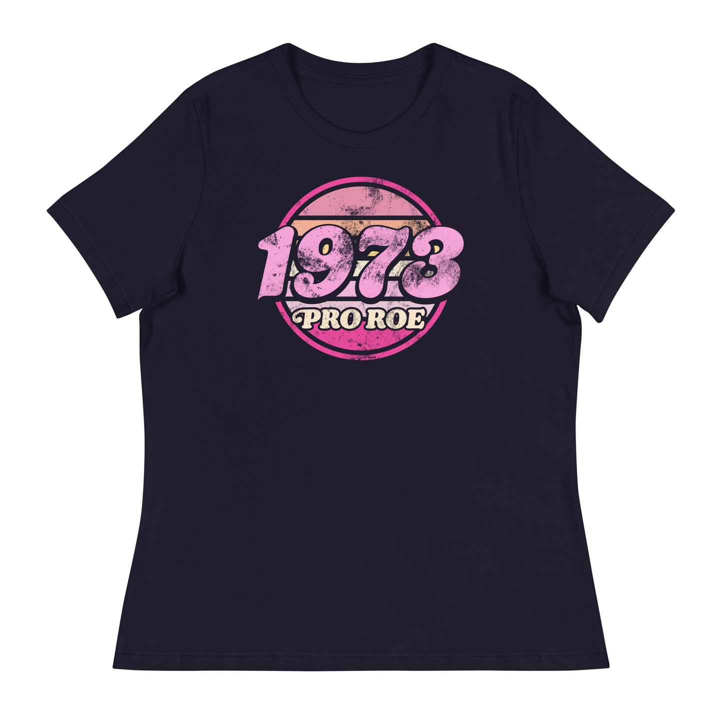 Navy women’s relaxed t-shirt featuring a distressed retro circular badge in pink and cream reading “1973 PRO ROE,” vintage reproductive freedom design centered on a dark garment.