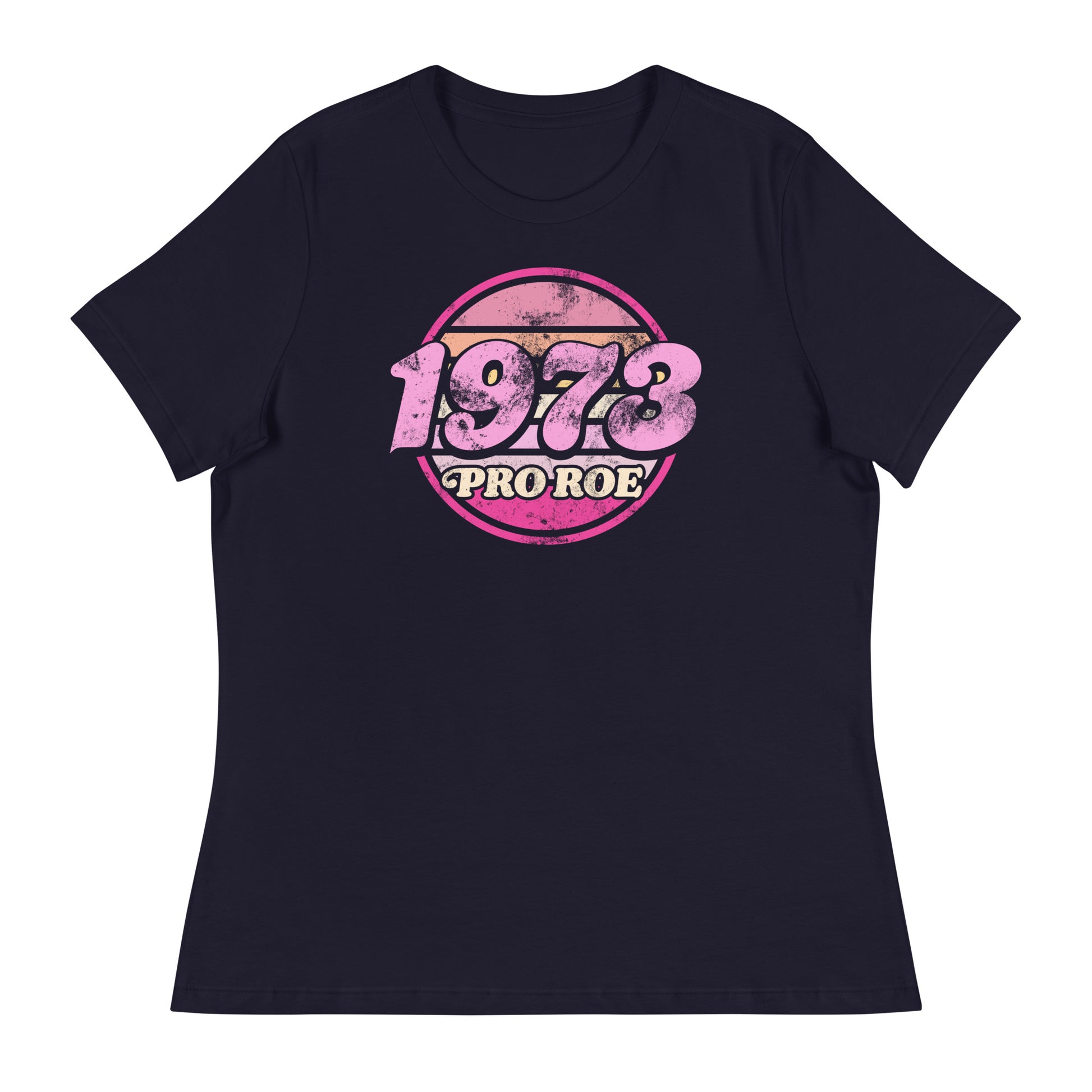 Navy women’s relaxed t-shirt featuring a distressed retro circular badge in pink and cream reading “1973 PRO ROE,” vintage reproductive freedom design centered on a dark garment.