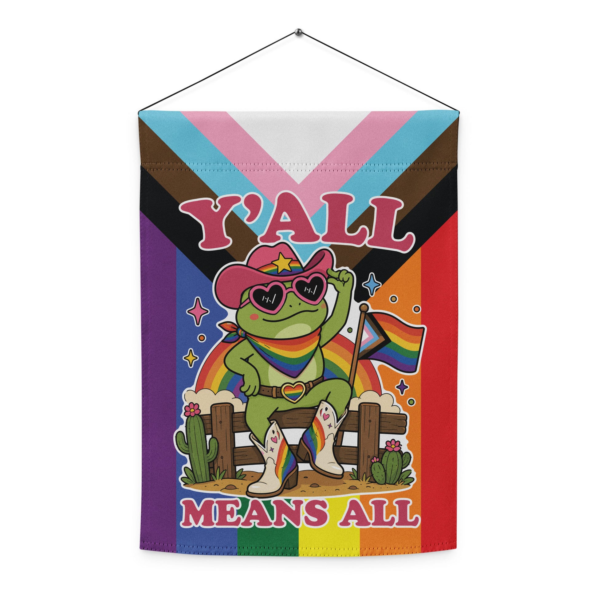Decorative garden flag displaying a rainbow cowboy frog holding a pride flag with vibrant Pride-inspired colors and inclusive “Y’All Means All” typography.